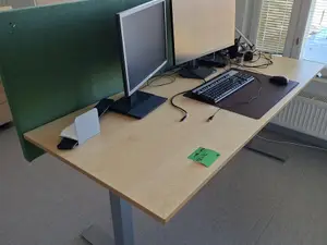 Sähköpöytä sermillä ja valaisimella